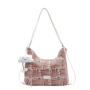 Reddish-brown woven canvas tote bag with white strap and cute cloud charm on white background