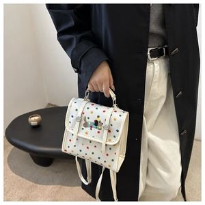 Detail of white crossbody bag with multi-color dots and cute cartoon puppy embroidery