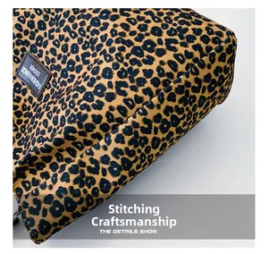 Close-up of precise stitching craftsmanship on the leopard print canvas bucket bag