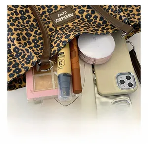 Detail view of leopard print canvas tote bag showing interior capacity and daily essentials