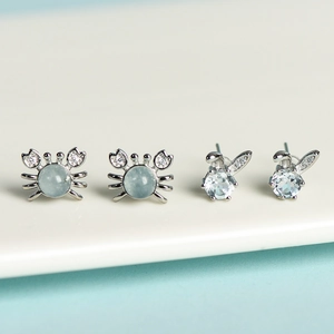 Cute crab and rabbit stud earrings with light blue gemstones and diamond accents