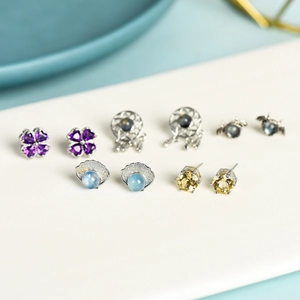 Mixed set of five crystal and gemstone earrings featuring hearts and dreamcatcher designs