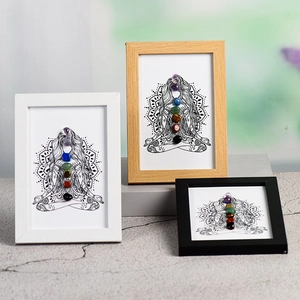 Yoga chakra wall art set with natural raw crystals in white wood and black frames
