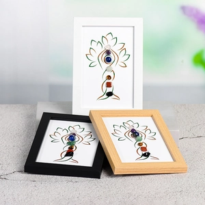 Three wooden frames featuring Tree of Life art with seven chakra natural raw stones