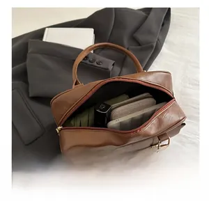 Internal capacity of brown pebble texture tote bag holding a phone, wallet, and cosmetics