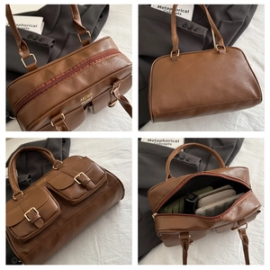 Detailed interior of vintage brown leather pillow bag showing large capacity and zipper