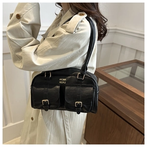 Detail of vintage black leather bowling bag showing double flap pockets and gold hardware