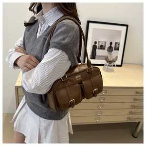 Detail of vintage brown leather bowling bag with twin buckle pockets and logo print