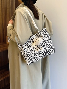 Classic black and white leopard print large tote bag with a white shoulder strap and plush charm