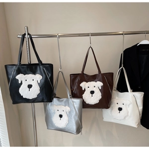 Detail view of large tote bags in four colors featuring plush Schnauzer puppy patches