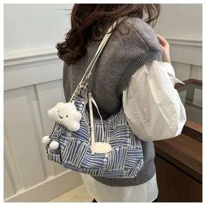 Blue and white patterned tote bag with soft cloud pendant and white shoulder strap