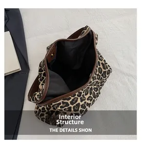 Internal view of leopard print tote bag showing black lining and magnetic closure detail