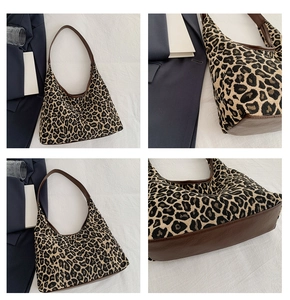 Close-up of leopard print tote bag detailing brown leather straps and fabric texture
