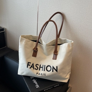 Canvas tote bag with brown leather straps and black Fashion Paris lettering