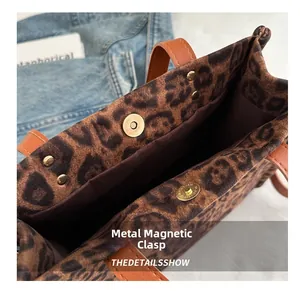 Detailed close-up of the leopard print tote bag featuring a secure metal magnetic clasp