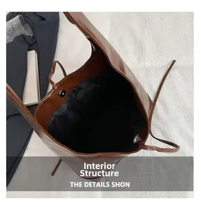 Detail view of the brown shoulder bag's internal structure with magnetic closure