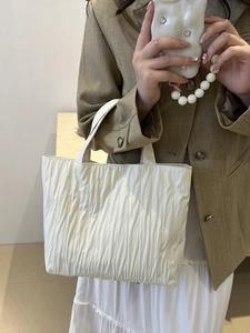 Minimalist white pleated tote bag with vertical textured fabric for women's daily commute