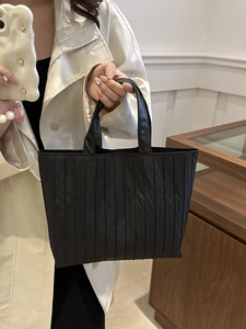 Minimalist black pleated tote bag with vertical stripes for commuting and daily leisure use