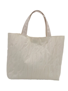 Minimalist creamy white pleated tote bag featuring vertical textured fabric and top handles