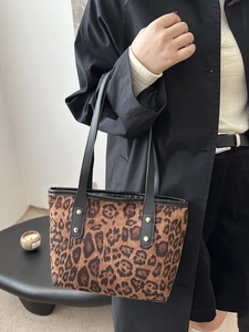 Elegante borsa tote leopardata con cinturini in pelle nera e borchie dorate