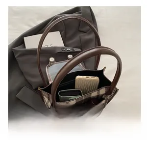 Detail view of plaid tote bag interior showing spacious capacity for phone and wallet