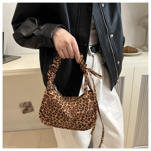 Detail of leopard print tote bag with ruched handle and side drawstring decoration