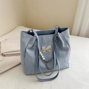 Silver commuter tote bag with pearl chain and metallic butterfly charm for women