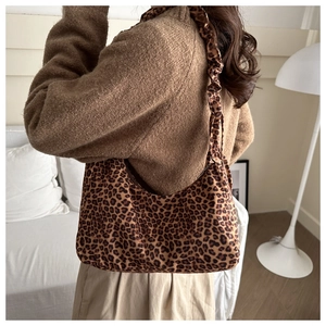 Detailed side view of leopard print hobo bag with trendy ruched shoulder strap detail