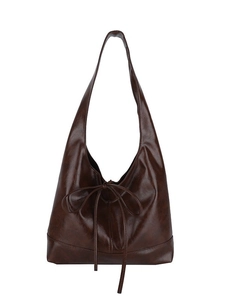 Minimalist dark brown tote bag with ribbon bow detail and integrated wide shoulder strap