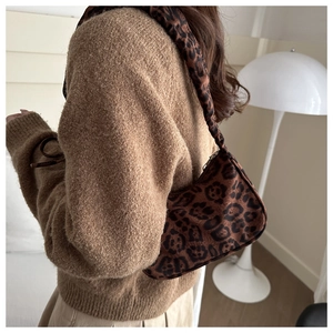 Detailed view of leopard print shoulder bag fabric and matching crossbody strap
