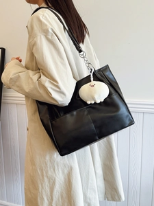 Elegant black large-capacity tote bag with silver chain straps and plush charm