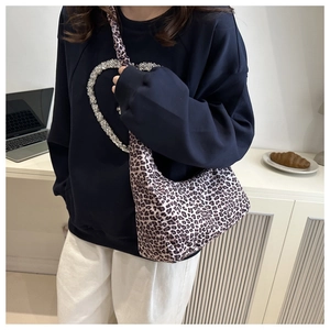 Detail of leopard print shoulder bag styled with casual outfit in a daily office setting