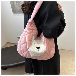 Detailed shot of pink quilted shoulder bag with white fluffy dog patch on nylon fabric