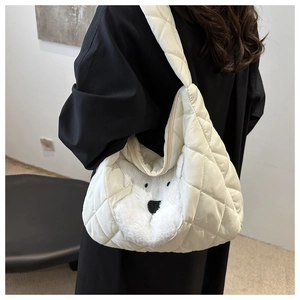Detail of white quilted tote bag featuring a plush cartoon puppy face design and zipper