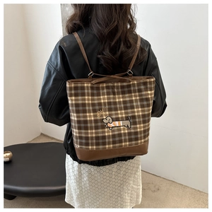 Detail of dachshund embroidery and brown plaid canvas on this large tote bag