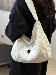 Quilted white shoulder bag with cute polar bear patch in a stylish crossbody carry