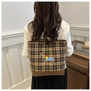 Detail of brown plaid tote bag featuring a cute dachshund embroidery and "OH!" text