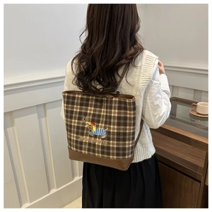 Detail of dachshund embroidery on brown checkered tote bag with Oh! text and leather base