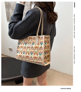 Detail of vintage geometric jacquard tote bag with colorful diamond pattern and beige handles