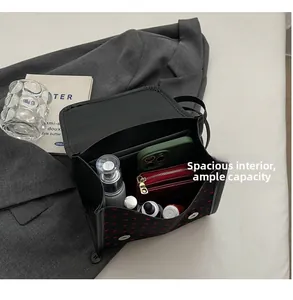 Detail view of the spacious inner compartment of the heart-patterned crossbody bag