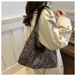 Detail showing the large capacity leopard print tote bag with black shoulder strap