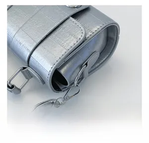 Detail of silver textured handbag with premium metallic hook and polished finish
