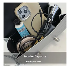 Internal capacity of silver crocodile texture bag showing space for phone and makeup