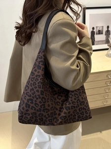 Chic leopard print canvas shoulder bag with large capacity in a minimalist interior