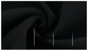 Close-up of soft black knitted cotton fabric showing breathable texture and A-class safety