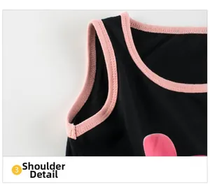 Close-up of shoulder seam and pink trim on black floral sleeveless cotton dress
