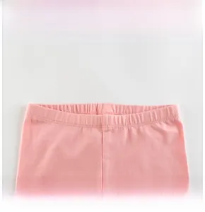Detail of pink girls' leggings featuring a wide elastic waistband and fine stitching