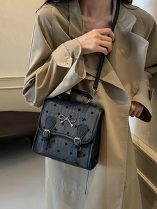 Retro grey herringbone backpack with flocking dots and a silver metal bow buckle