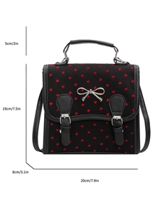 Black heart pattern crossbody bag with silver bow accent and dimensions shown