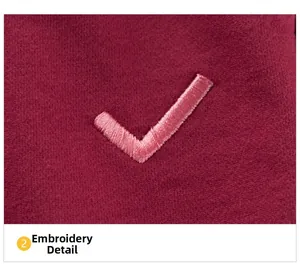 Macro shot of high-density pink check embroidery on burgundy autumn jogger pants